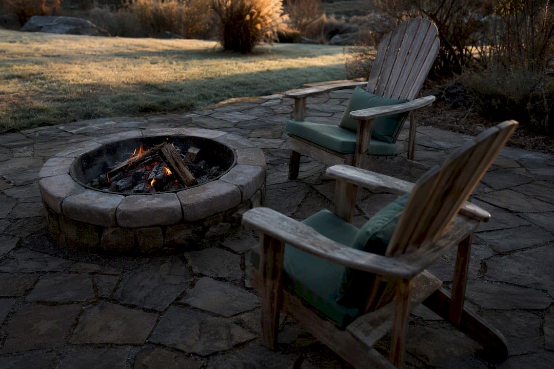 Adirondack chairs arranged around fire pit
