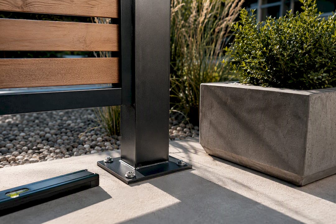 Anchored privacy screen beside patio planter