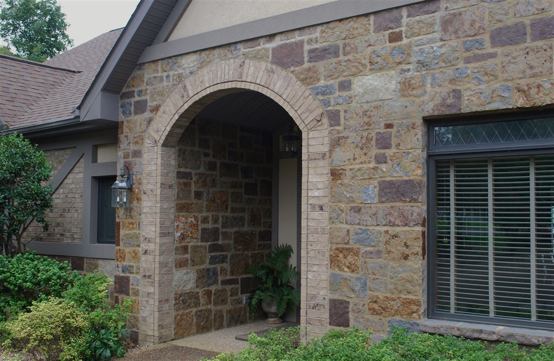Arched entry, mosaic stone with a cut-stone arch