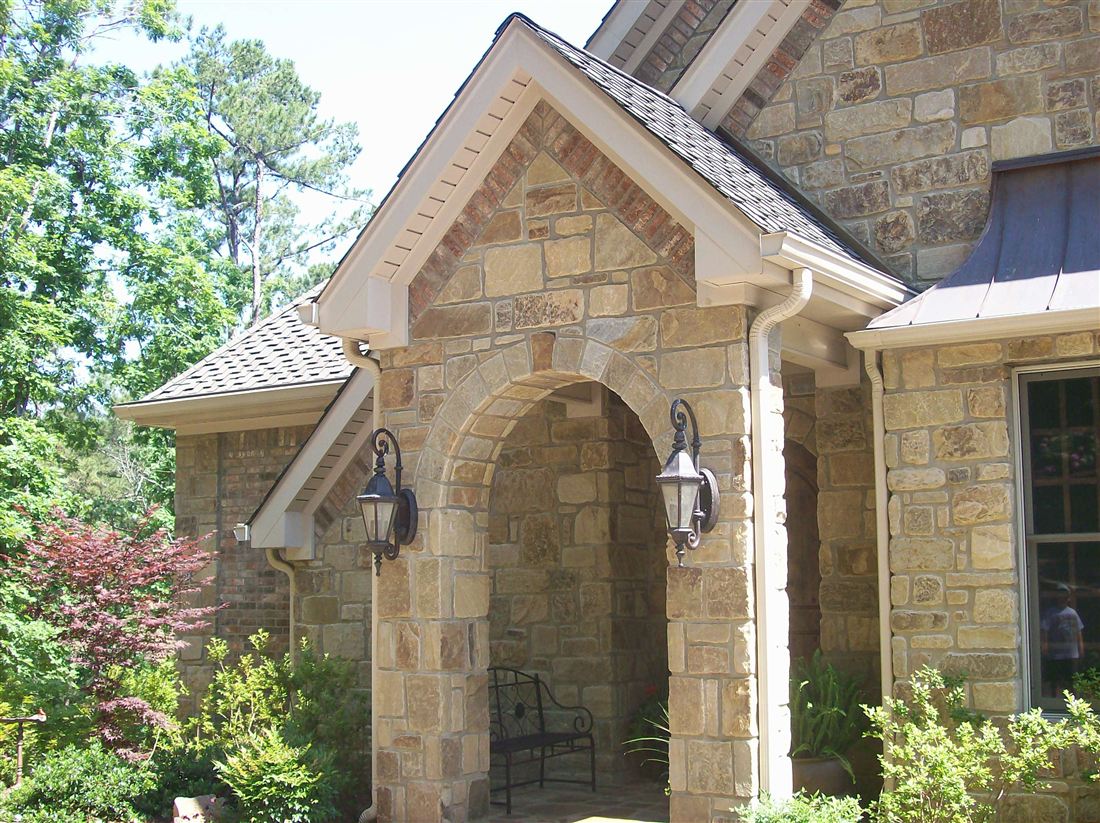 Arched limestone entry, with lanterns