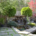 Backyard waterfall and pond, stone slab bridge, flagstone edge