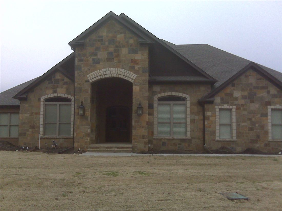 Chopped stone and stucco, arched entry