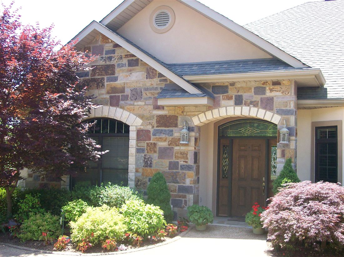 Chopped-stone entry, with landscaping