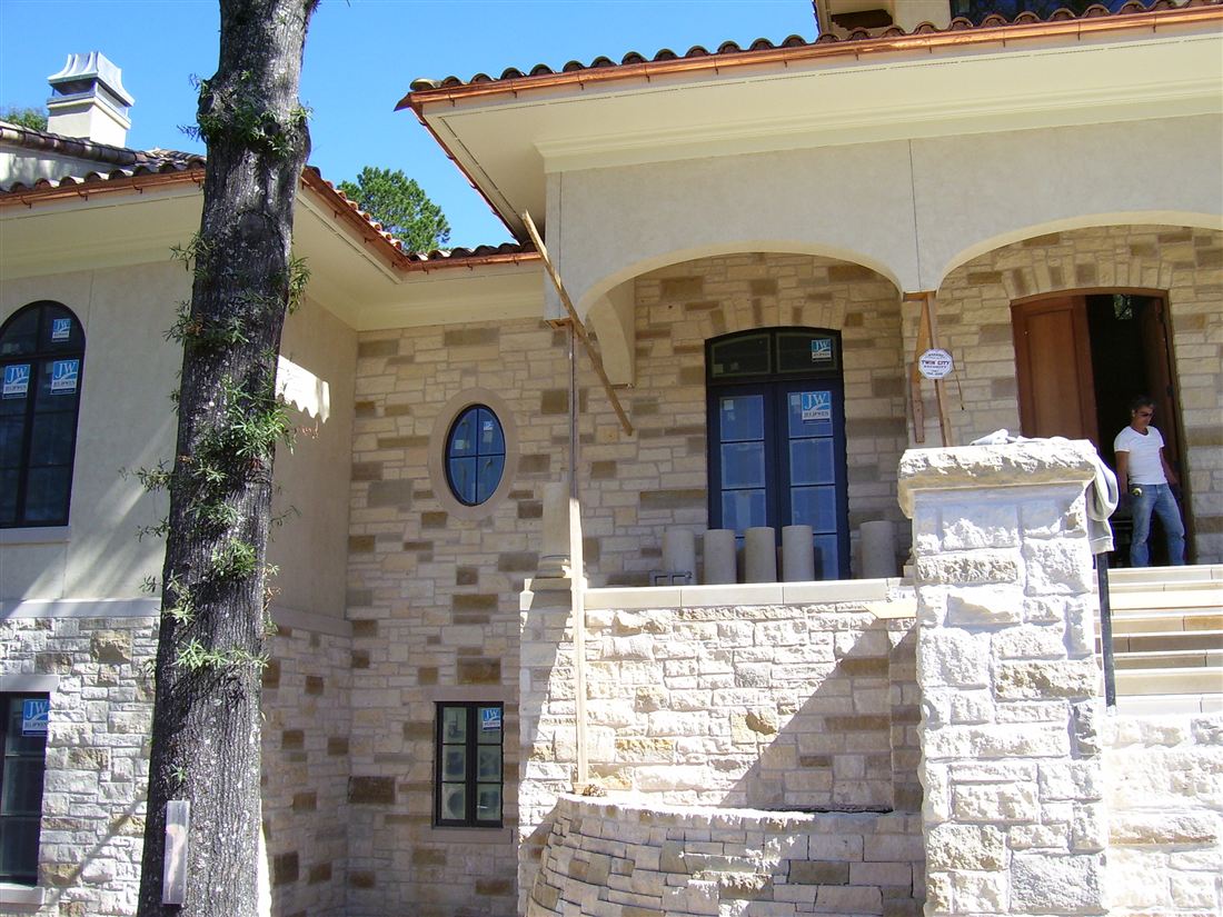 Cut limestone, under a tile roof