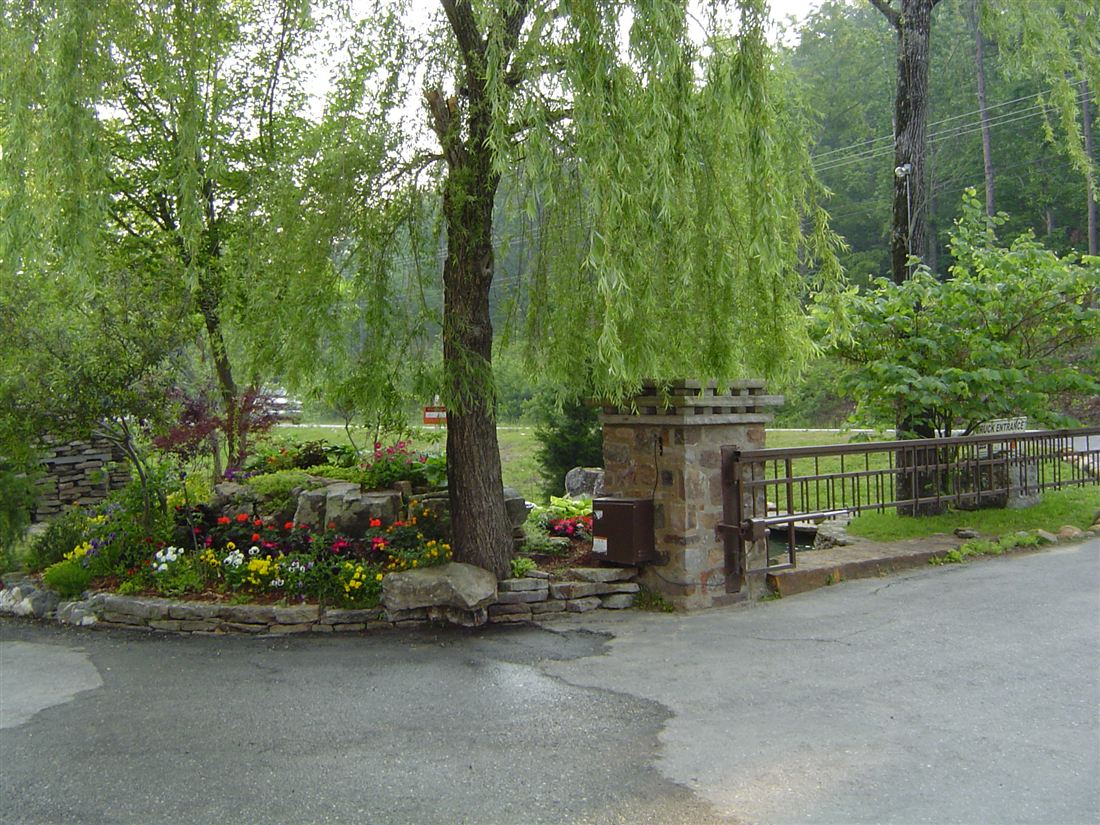 Entry columns and iron gate, with a planted island
