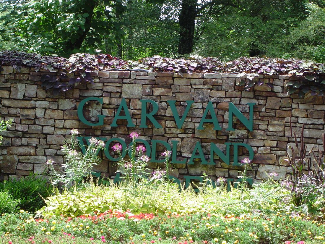 Entry sign wall, dry-stack ledge stone with a planted cap