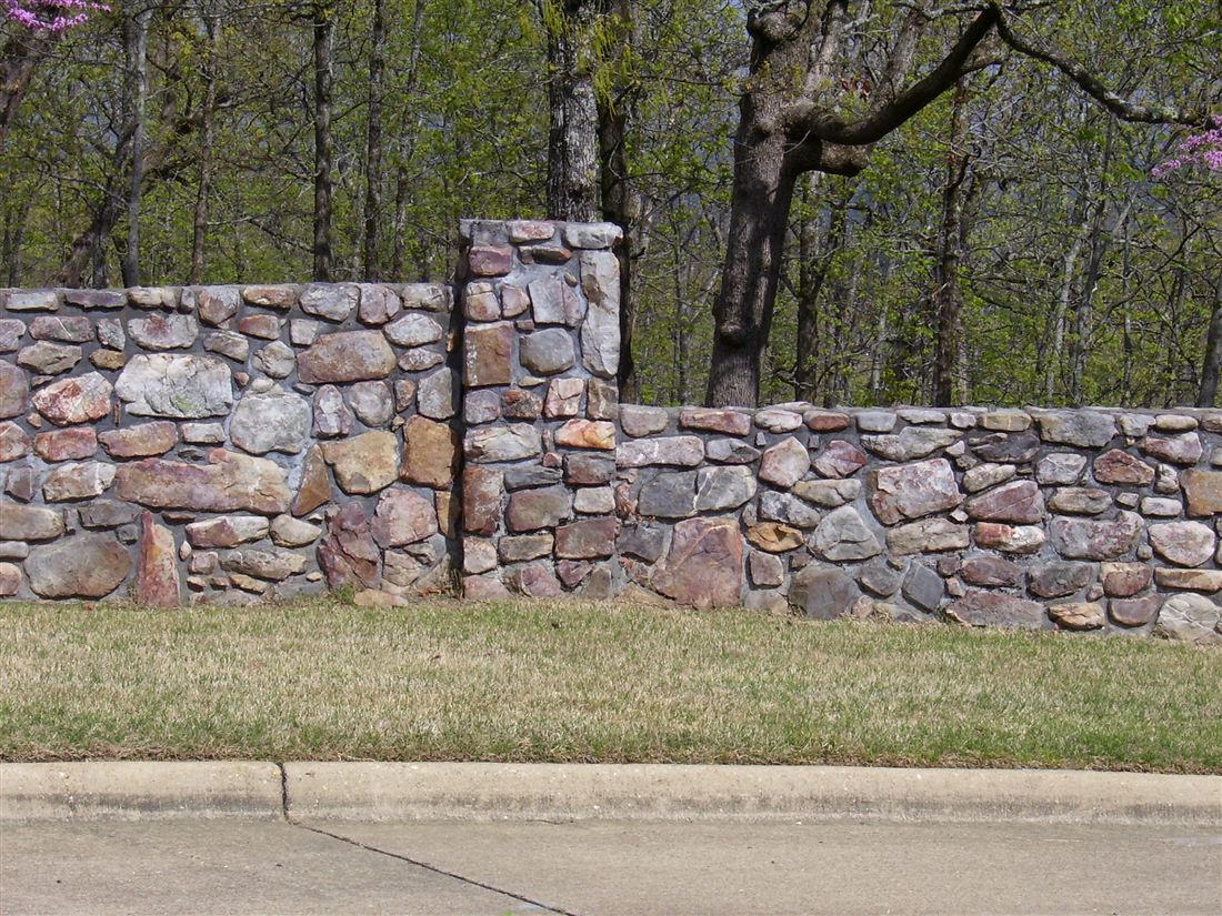 Fieldstone wall, column and iron fence