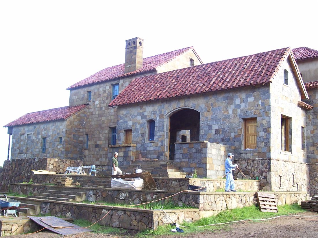 Finished wing, arched entry and stone stair walls
