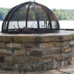 Fire pit on the water, chopped stone, screen dome