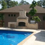 Fireplace and grill, cut limestone, beside the pool