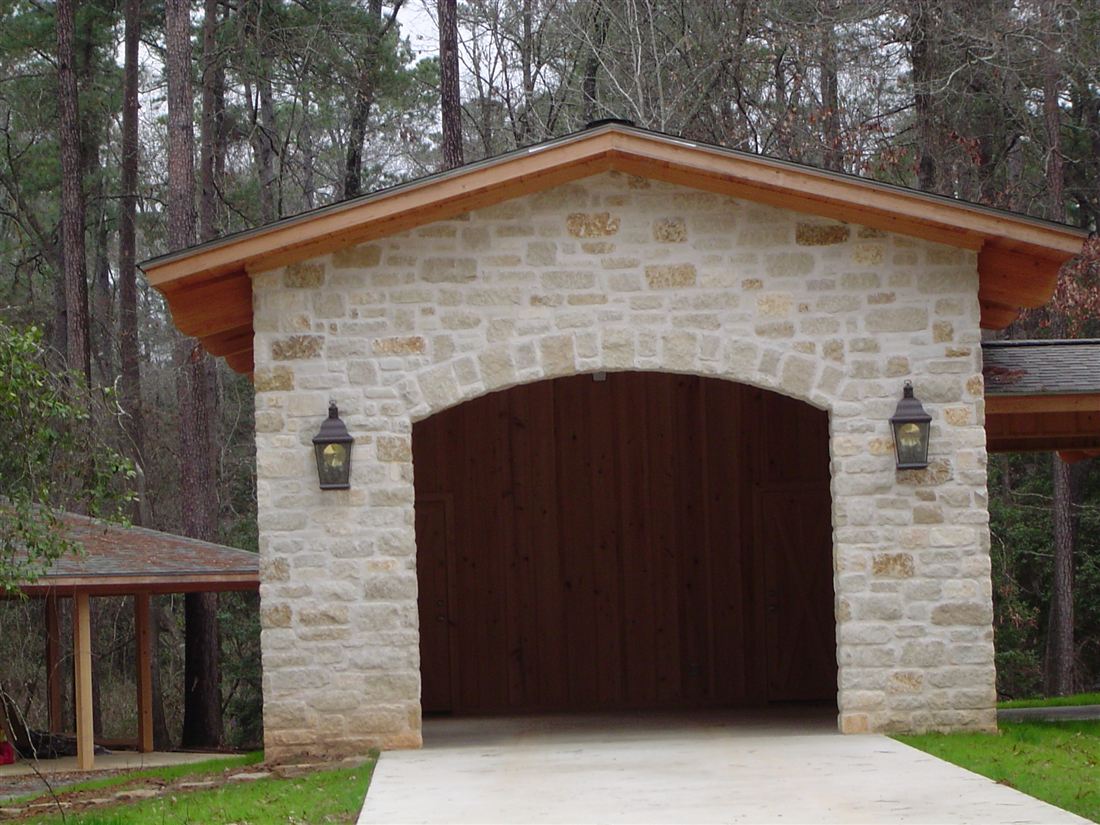 Garage, limestone with an arched carriage door