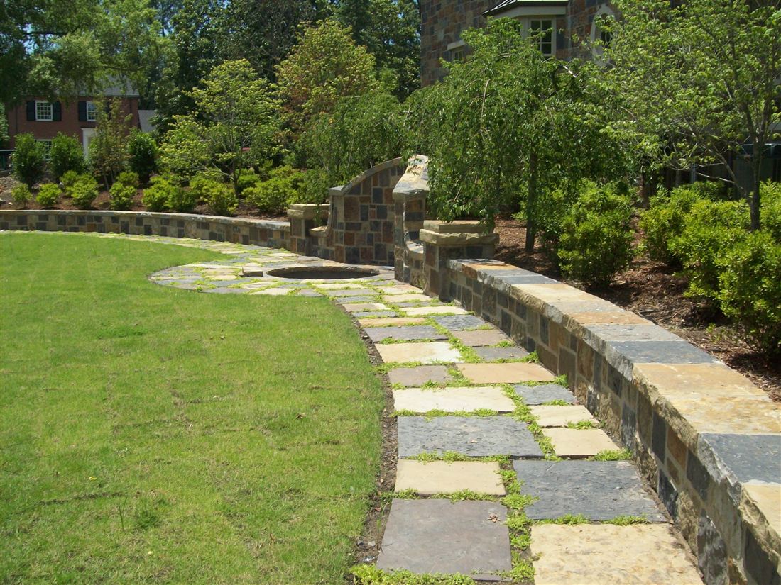 Garden courtyard, random-rectangle paving with grass joints, curved seat wall