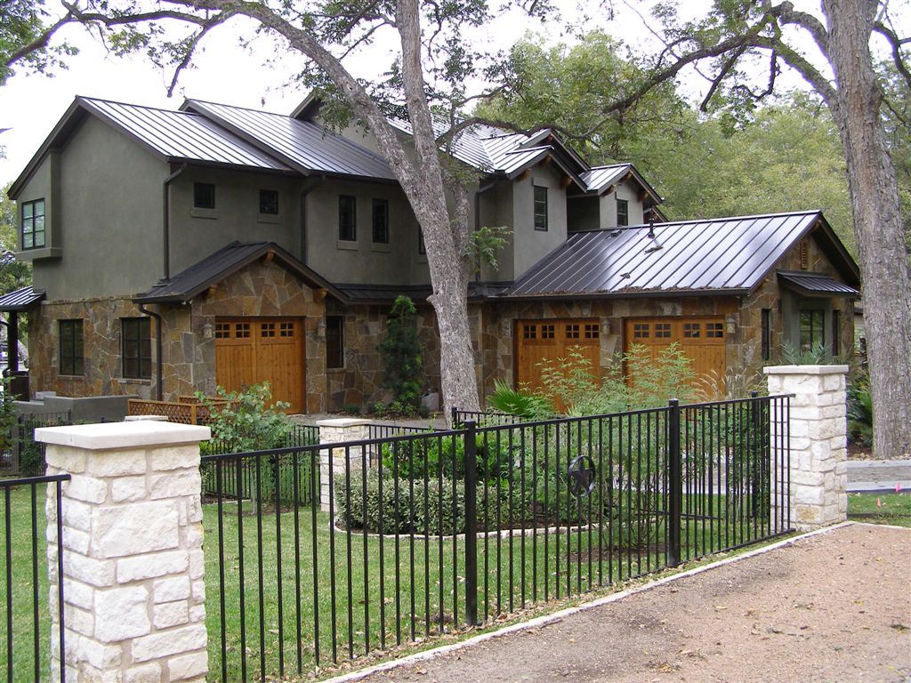 Hill-country stone, limestone columns and iron fence