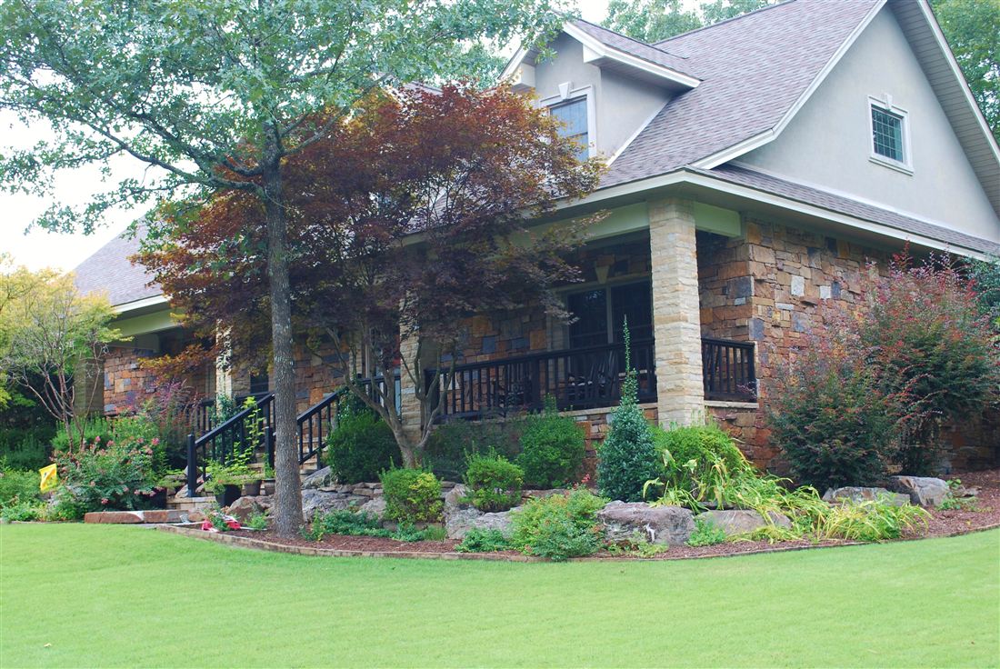 Ledge-stone lodge, porch columns and boulder beds