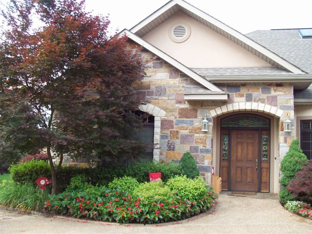 Mosaic-stone entry, Japanese maples and clipped beds