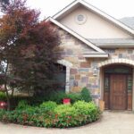 Mosaic-stone entry, Japanese maples and clipped beds