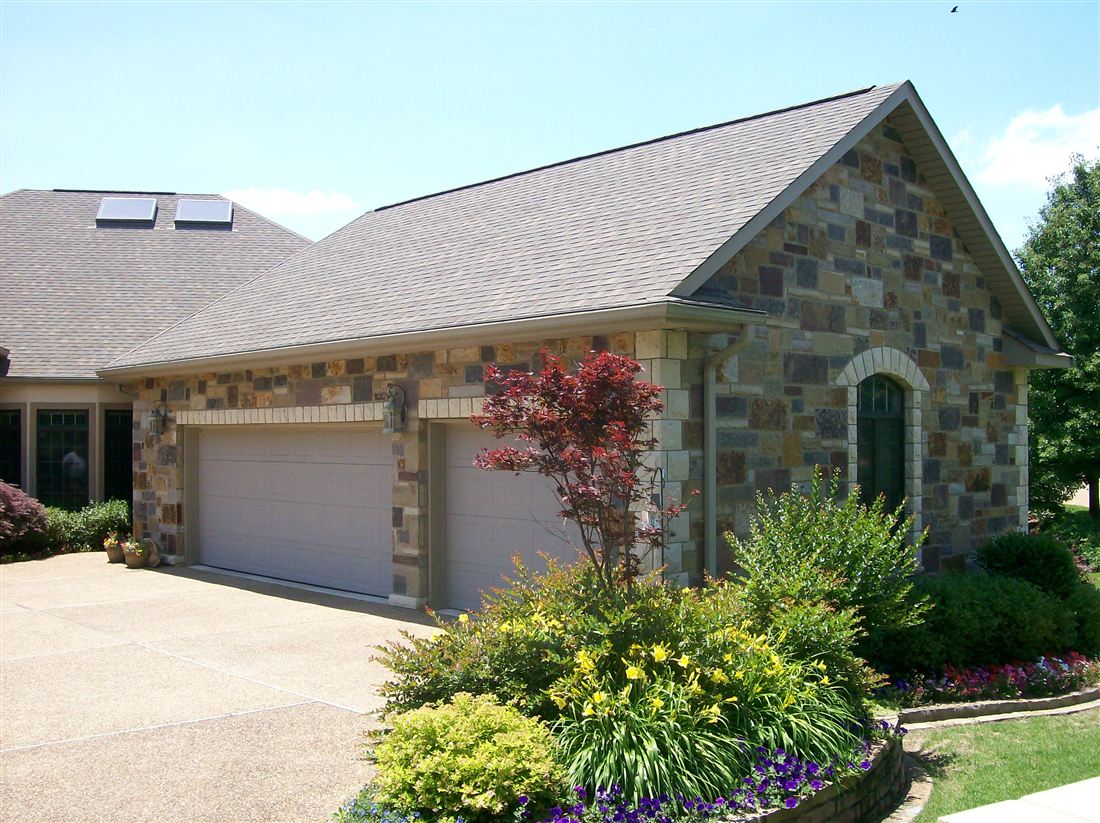 Multi-color chopped stone, garage and beds