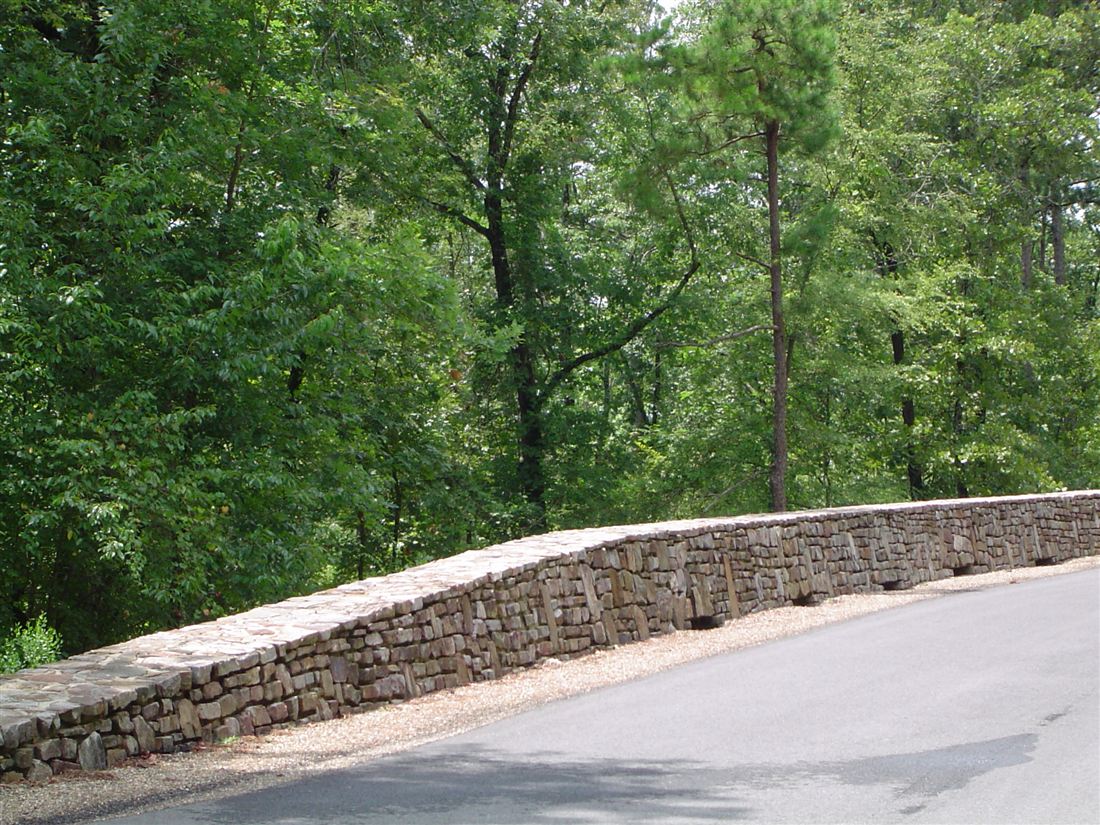 Road wall at the bridge, curved dry-stack ledge stone with a cut cap