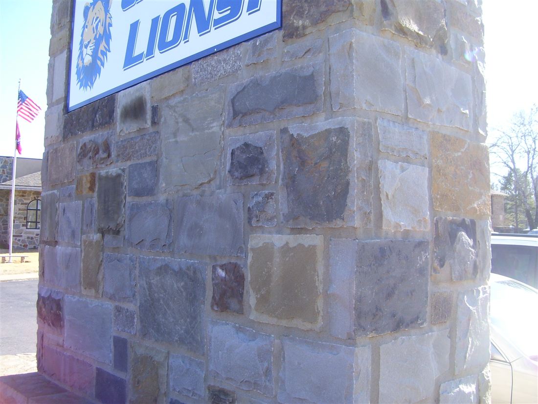 School sign pillar, mixed chopped stone