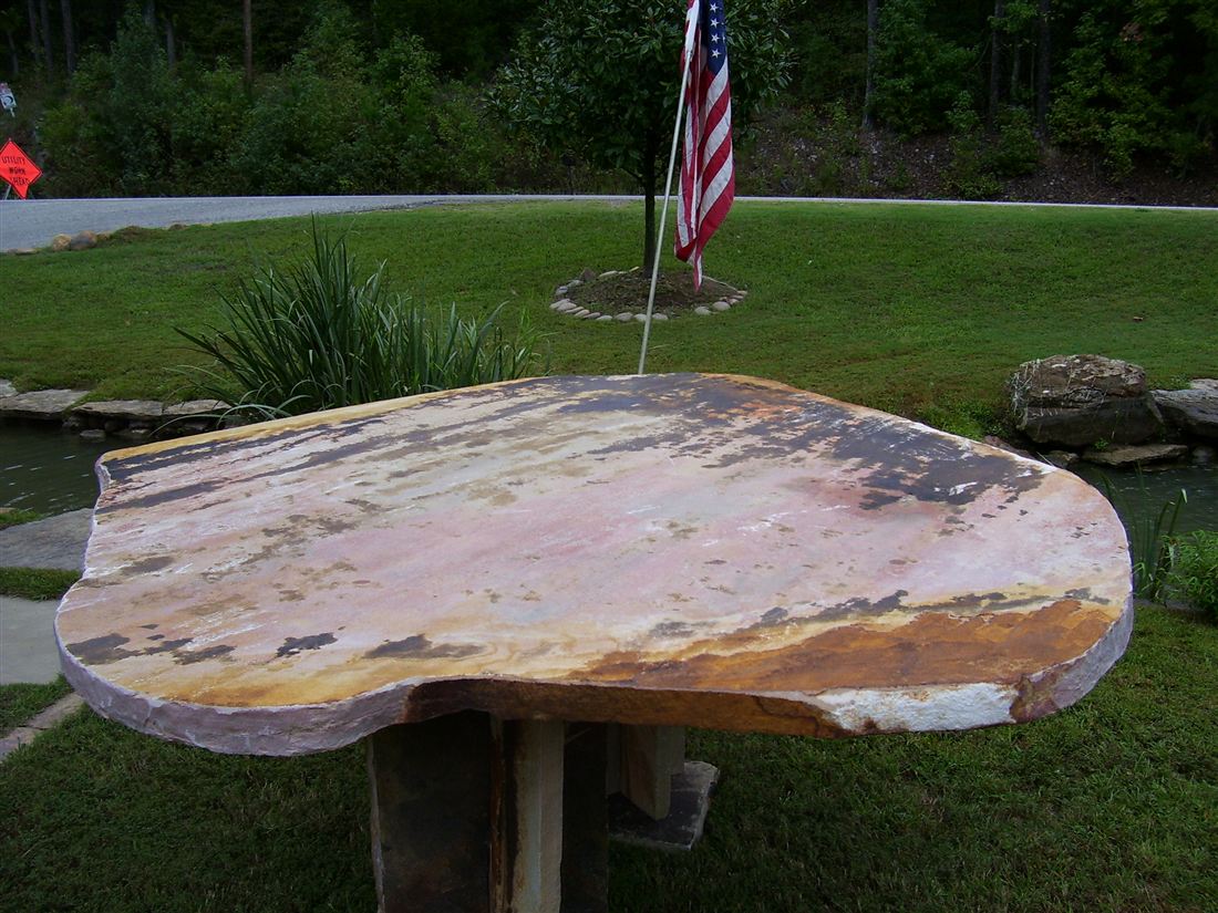 Slab table, on a stone pedestal