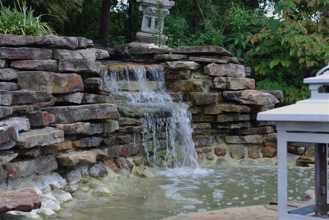 Stacked-stone waterfall, spilling into the pool