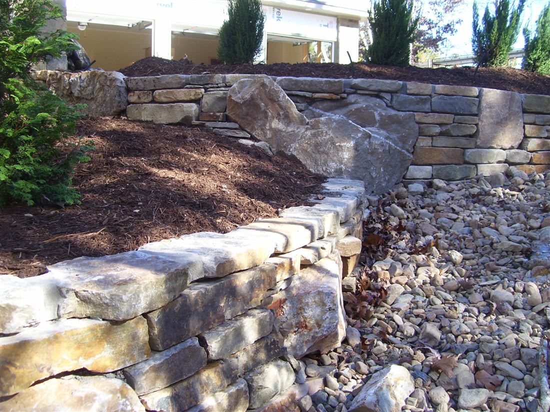 Stacked wall, over creek rock