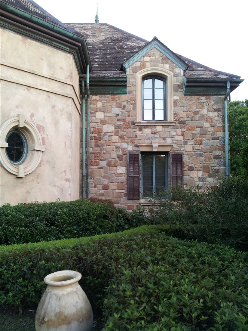 The house, stone and stucco with urn