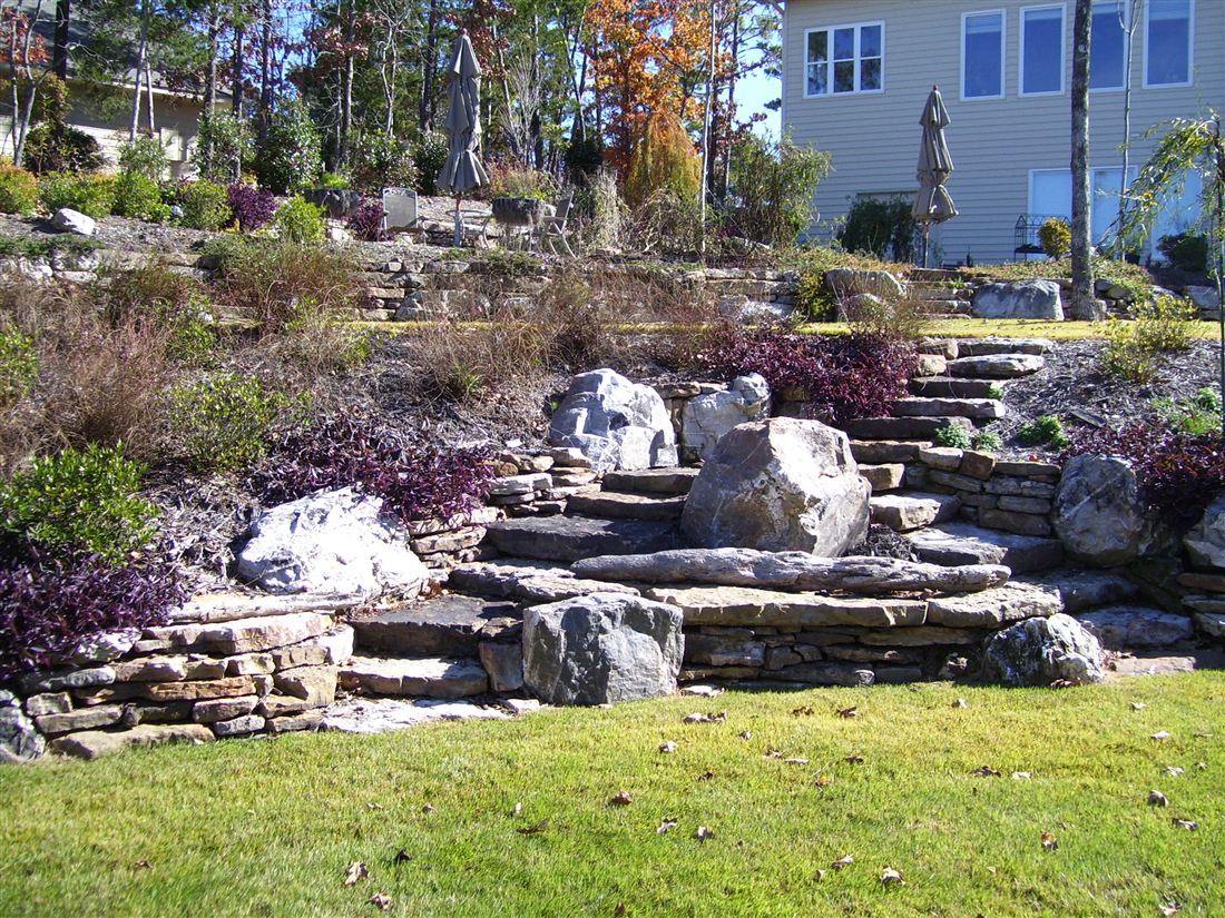 Three tiers of dry-stack sandstone, boulder accents, slab steps and fall color
