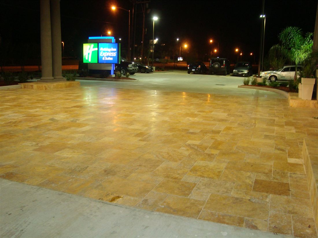 Tumbled gold travertine, hotel breezeway at night