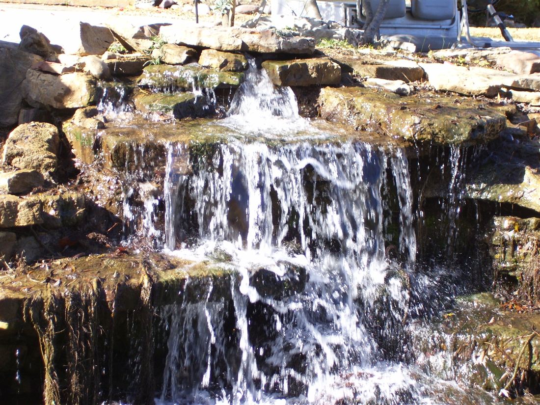 Waterfall, boulders at the top of the slope